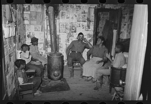 Untitled photo, possibly related to: Southeast Missouri Farms. Children sitting in living room of shack home