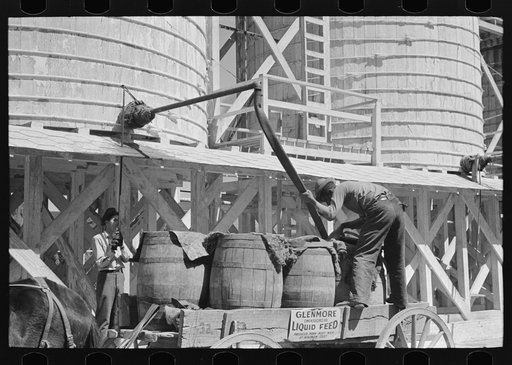 Untitled photo, possibly related to: Loading liquid feed onto truck from tanks at distillery near Owensboro, Kentucky