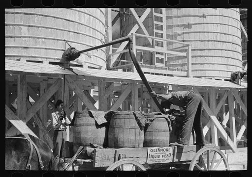 Untitled photo, possibly related to: Loading liquid feed onto truck from tanks at distillery near Owensboro, Kentucky