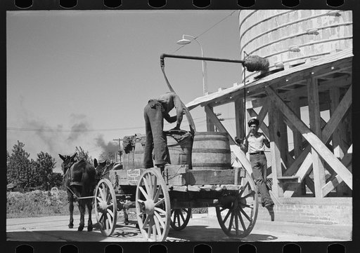 Loading liquid feed onto truck from tanks at distillery near Owensboro, Kentucky