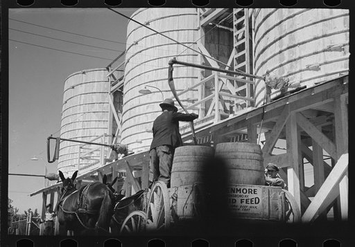 Untitled photo, possibly related to: Loading liquid feed onto truck from tanks at distillery near Owensboro, Kentucky