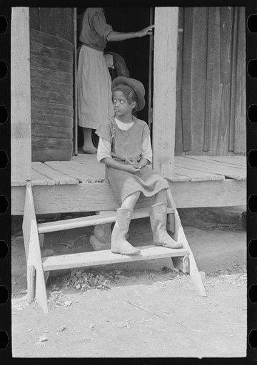 Daughter of sharecropper on steps of front porch, New Madrid County, Missouri