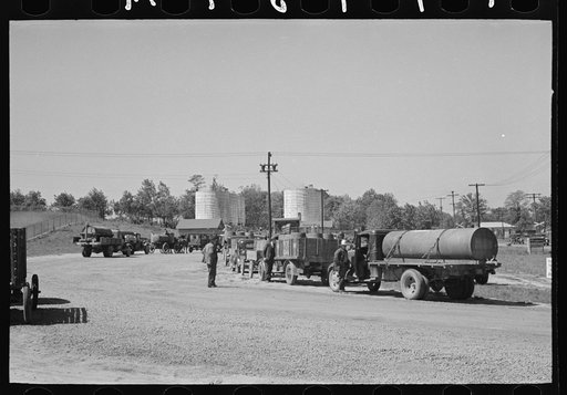 Untitled photo, possibly related to: Loading liquid feed onto truck from tanks at distillery near Owensboro, Kentucky