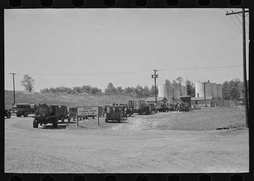 Untitled photo, possibly related to: Loading liquid feed onto truck from tanks at distillery near Owensboro, Kentucky