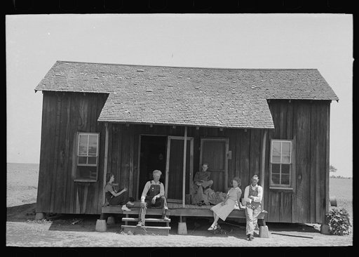 Family of farmer sharecropper on front porch of shack home. Southeast Missouri Farms