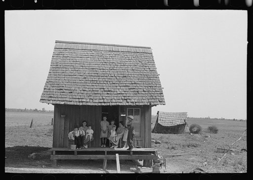 Sharecropper family on front porch of cabin, New Madrid County, Missouri