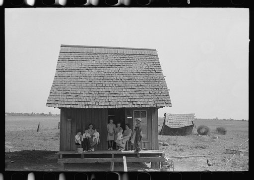 Untitled photo, possibly related to: Sharecropper family on front porch of cabin, New Madrid County, Missouri