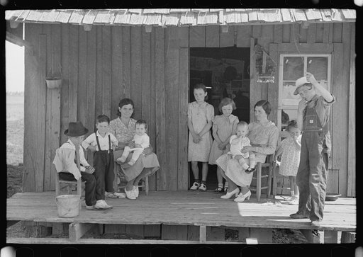 Untitled photo, possibly related to: Sharecropper family on front porch of cabin, New Madrid County, Missouri