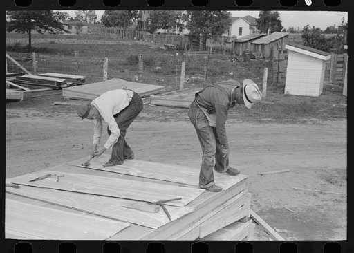 Untitled photo, possibly related to: Roof decks for house porches are completely shop assembled. Putting on sheet metal roofing. House plant. Southeast Missouri Farms Project