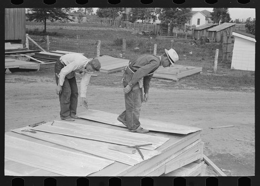 Untitled photo, possibly related to: Roof decks for house porches are completely shop assembled. Putting on sheet metal roofing. House plant. Southeast Missouri Farms Project