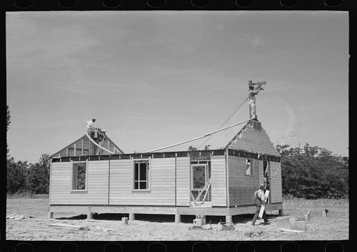 Untitled photo, possibly related to: Southeast Missouri Farms Project. Field house erection. Fitting gable ends in place