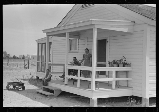 Untitled photo, possibly related to: Southeast Missouri Farms. Family of FSA (Farm Security Administration) client, former tenant farmer, on front porch of new home