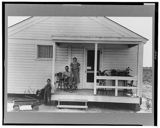 Southeast Missouri Farms. Family of FSA (Farm Security Administration) client, former tenant farmer, on front porch of new home