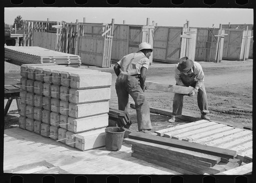 Outbuilding plant. Stacking precast concrete mud sills for privies. Precast house piers at left. Southeast Missouri Farms Project