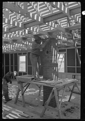Untitled photo, possibly related to: Southeast Missouri Farms Project. House erection. Building chimney complete before any finish is applied to the house
