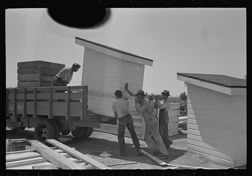Southeast Missouri Farms Project. Loading completed privy houses on truck for delivery to site