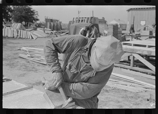 Untitled photo, possibly related to: House plant. Gasoline saw being adjusted for ripping purposes. Southeast Missouri Farms Project