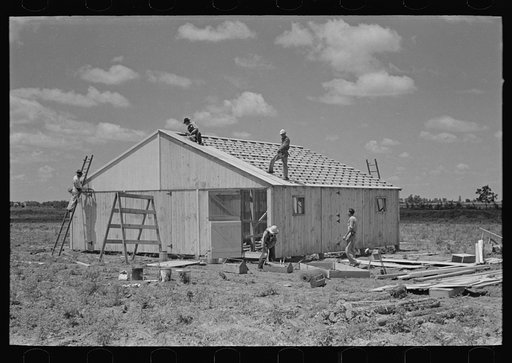 Untitled photo, possibly related to: Barn erection. Placing corrugated metal roofing. Southeast Missouri Farms Project