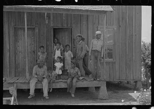 Sharecropper family on front porch, New Madrid County, Missouri