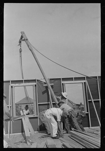 Southeast Missouri Farms Project. House erection. Placing gin pole to erect the gable end