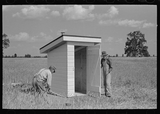 Untitled photo, possibly related to: Southeast Missouri Farms Project. Final operation in setting of sanitary privy at the job site