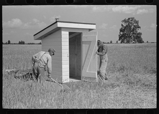 Southeast Missouri Farms Project. Final operation in setting of sanitary privy at the job site
