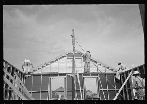 Southeast Missouri Farms Project. House erection. Fastening gable end in place
