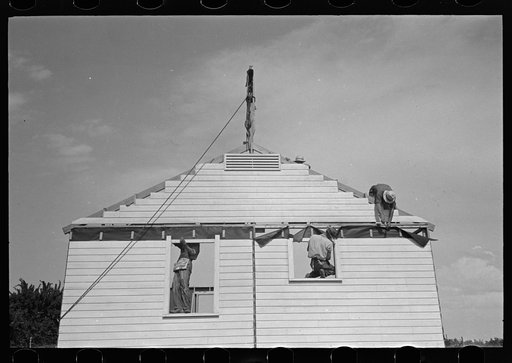 Untitled photo, possibly related to: Southeast Missouri Farms. Erecting gable end on house