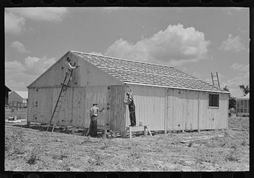Barn erection. Beginning prime coating of completely erected barn in field. Southeast Missouri Farms Project