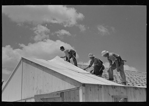 Barn erection. Placing metal roofing. Southeast Missouri Farms Project