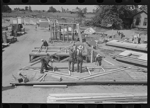 House plant. Truss is lifted out of jig and back, nailed before stacking. Southeast Missouri Farms Project