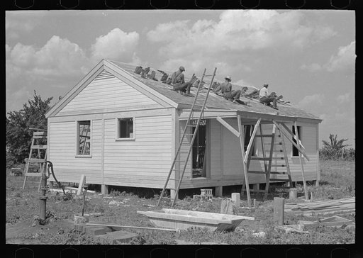 Southeast Missouri Farms Project. House erection. Roofing over shingle lath with wood shingles