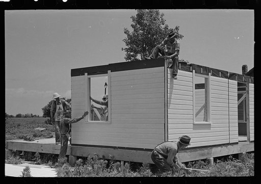 Untitled photo, possibly related to: Southeast Nissouri Farms Project. House erection. View of exterior corner as panels are erected
