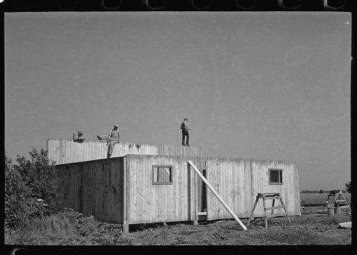 Erecting panels of prefabricated barn, Southeast Missouri Farms