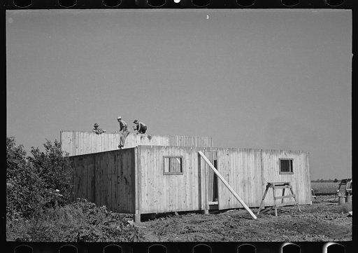 Untitled photo, possibly related to: Erecting panels of prefabricated barn, Southeast Missouri Farms