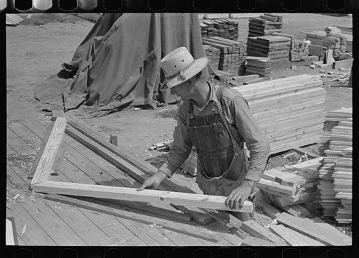 Food storage plant. Placing precut rafters in jig for making trusses. Southeast Missouri Farms Project