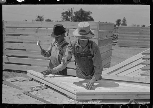 Nailing on rake board of food storage gable end, Southeast Missouri Farms Project