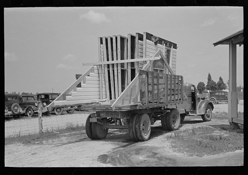 House erection. Delivery of materials. Completed standard load of shop assembled panels. Southeast Missouri Farms Project