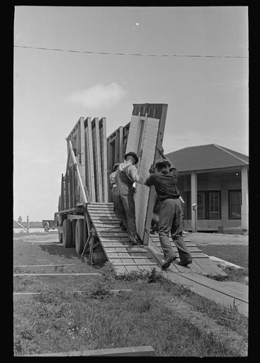 House erection. Delivery of materials. Standard panel load is made up in the order in which panels are to be handled at the job site. Southeast Missouri Farms Project