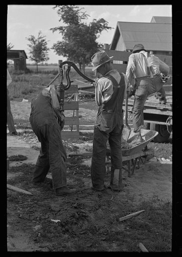 Southeast Missouri Farms Project. Fastening pump on well