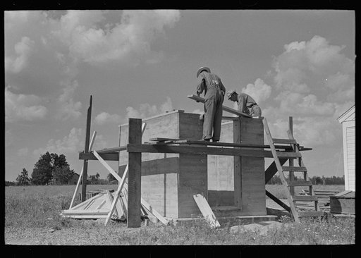 Food storage. Forms stripped from walls. Bolting on plates for roof construction. Southeast Missouri Farms Project