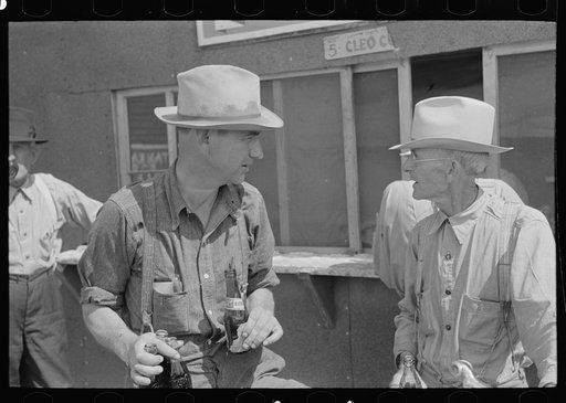 Farmers at auction with soft drinks, Sikeston, Missouri