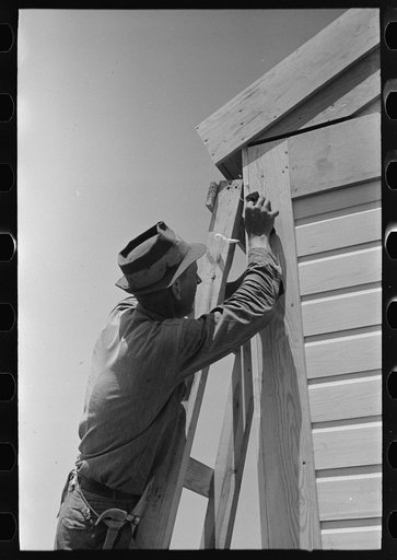 Untitled photo, possibly related to: Southeast Missouri Farms Project. Finishing off corner board of one of the new houses