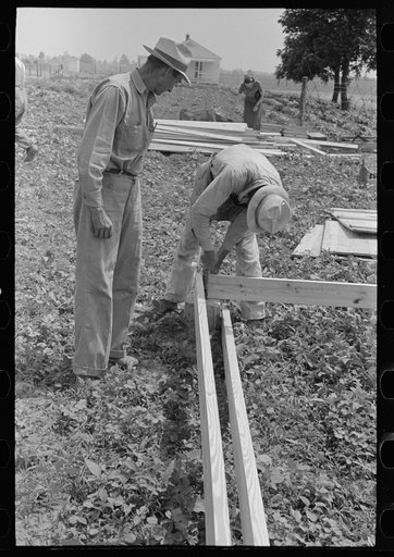 Untitled photo, possibly related to: Barn erection. Nailing together precut girders in barn floor system. Southeast Missouri Farms Project