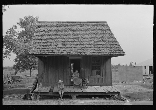 Front of sharecropper cabin. Note absence of posts holding up roof. Southeast Missouri Farms