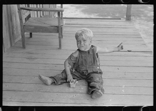 Untitled photo, possibly related to: Sharecropper family on front porch of cabin, Southeast Missouri Farms