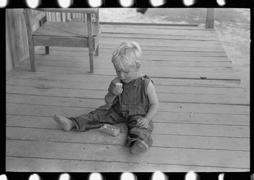Untitled photo, possibly related to: Sharecropper family on front porch of cabin, Southeast Missouri Farms