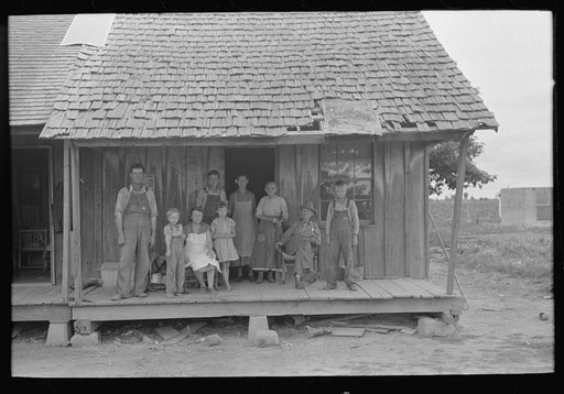 Sharecropper family on front porch of cabin, Southeast Missouri Farms