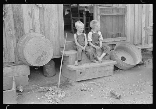 Children of sharecropper sitting on steps of cabin home, New Madrid County, Missouri