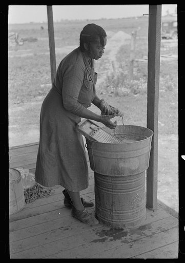 Wife of sharecropper washing clothes, Southeast Missouri Farms